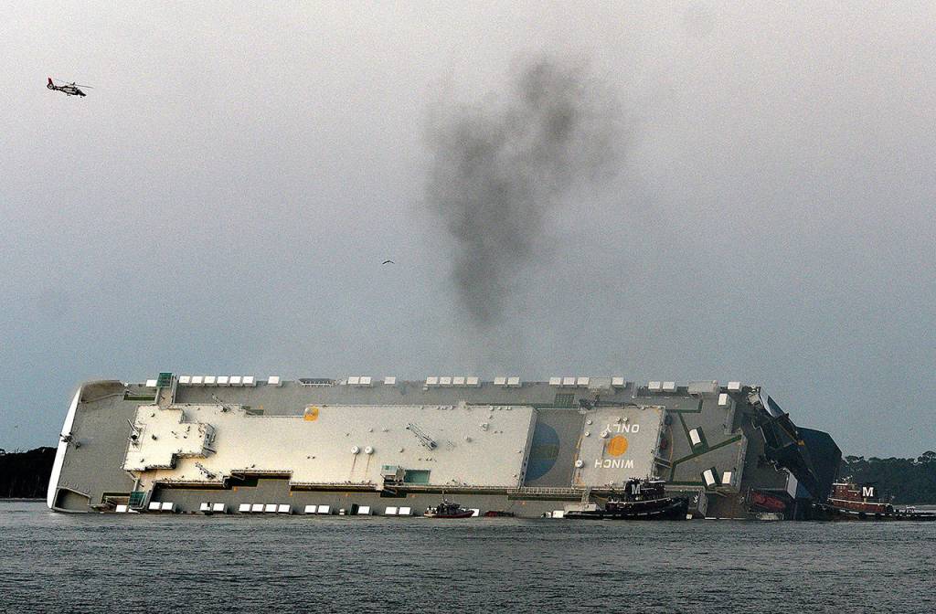 Smoke rises from a cargo ship that capsized in St. Simons Island Sound in Georgia on Sunday. (Bobby Haven / The Brunswick News)