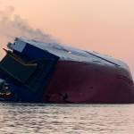 An overturned cargo vessel burns Sunday in St. Simons Sound, Georgia. (U.S. Coast Guard)