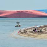 Rescuers contact men trapped deep inside capsized cargo ship