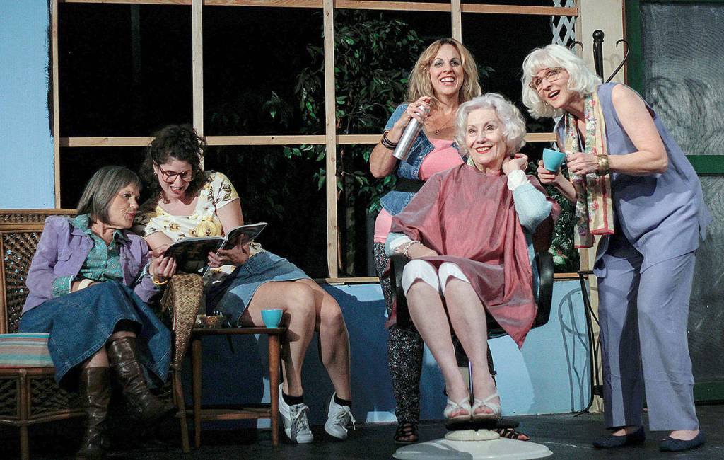 Ouiser (Dawn Cornell) and Annelle (Lydia ODay) share celebrity gossip while Truvy (Jenny Price) styles Clairees hair (Mary Kay Voss) and MLynn (Marli Bartness) looks on, in Red Curtains production of Steel Magnolias. (Layton Gaskins)