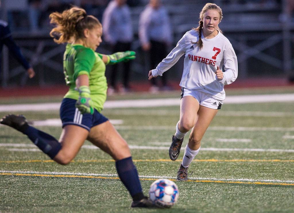 Snohomishs Ruthie Hammer puts pressure on Glacier Peak goalkeeper Neomi MacMillan during a non-conference girls soccer game Tuesday at Glacier Peak High School in Snohomish. (Olivia Vanni / The Herald)