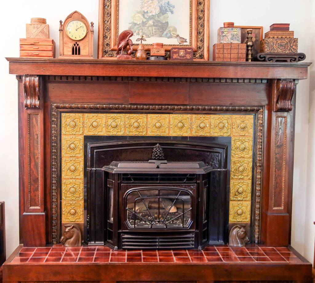 The original fireplace mantle and added tile work is part the Hendrie House of 1902, home to Candice Jarrett and husband David Cordell in Snohomish and part of the upcoming historic homes tour. (Kevin Clark / The Herald)                                The 117-year-old Hendrie House still has its original fireplace mantle, with added tile work. (Kevin Clark / The Herald)