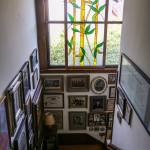 A stained glass panel and photos decorate the main stairase at the Hendrie house. (Kevin Clark / The Herald)                                A stained glass panel and photos decorate the main staircase at the home of Candice Jarrett and husband David Cordell. (Kevin Clark / The Herald)