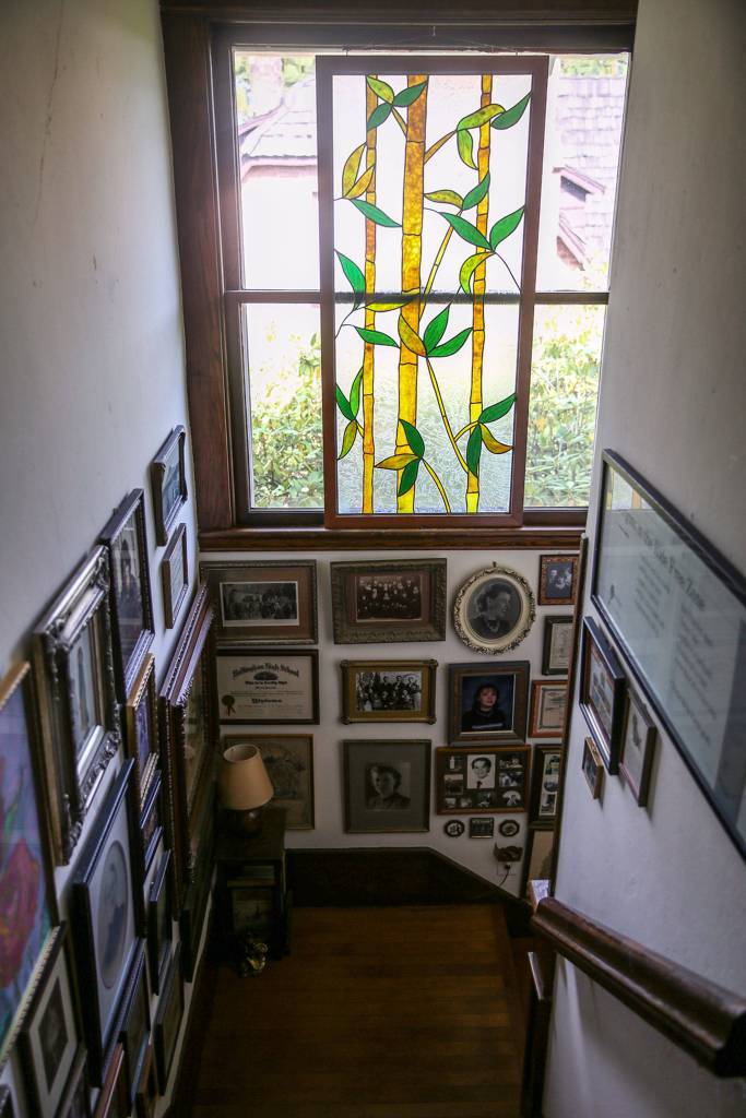 A stained glass panel and photos decorate the main stairase at the Hendrie house. (Kevin Clark / The Herald)                                A stained glass panel and photos decorate the main staircase at the home of Candice Jarrett and husband David Cordell. (Kevin Clark / The Herald)