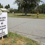 Signs have popped up in the Port Gardner neighborhood against a proposal by the Everett School District and Housing Hope to build affordable housing on a playfield on Norton Avenue. (Lizz Giordano / The Herald)