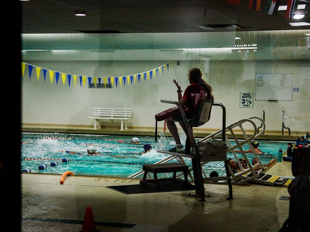 A lifeguard keeps an eye on swimmers in one of the indoor pools in the 1960 Everett Y building. Soon, swimmers will take their dips in new pools at the Ys brand-new facility. (Dan Bates / The Herald)