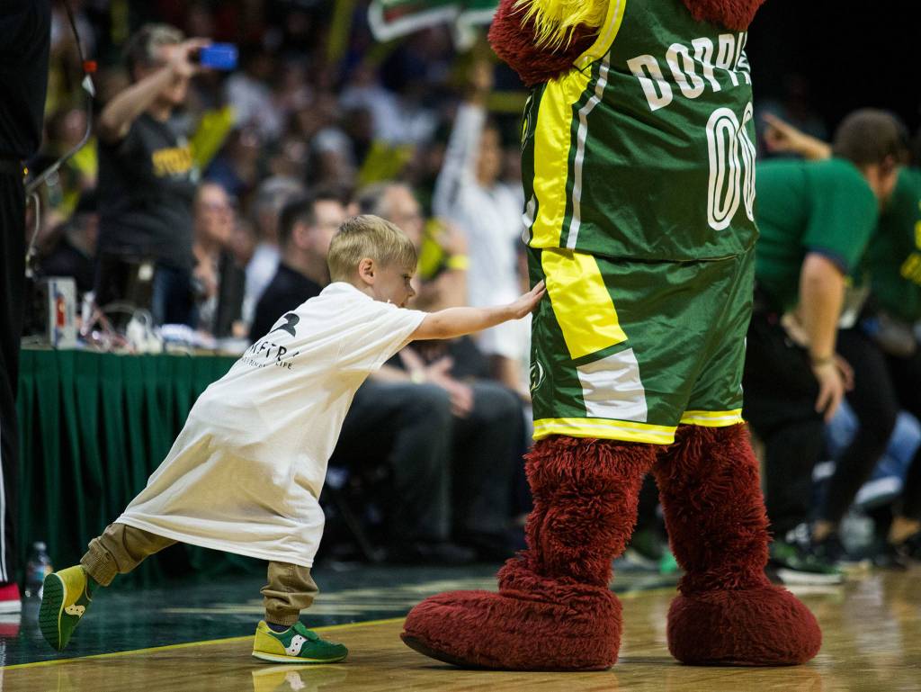 A fan reaches out to touch Doppler during the game against the Minnesota Lynx on Wednesday, Sept. 11, 2019 in Everett, Wash. (Olivia Vanni / The Herald)