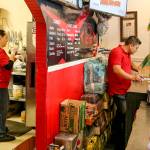 Deisy Ramos cooks in the back and her husband, Rigoberto Bastidak, takes orders at their restaurant, Taco-Book, in Everett. (Kevin Clark / The Herald)
