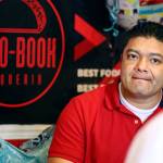 Rigoberto Bastida waits on a customer at Taco-Book in Everett. (Kevin Clark / The Herald)