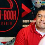 Rigoberto Bastida waits on a customer at Taco-Book in Everett. (Kevin Clark / The Herald)