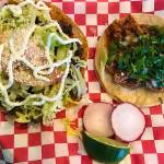 At Taco-Book, $4 buys a plate with a pork tostada and chicken taco, two of many menu options. (Andrea Brown / The Herald)