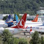 Dozens of grounded Boeing 737 Max airplanes crowd a parking area adjacent to Boeing Field in Seattle. (AP Photo/Elaine Thompson)