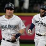 The Mariners Kyle Lewis (right) rounds the bases with Kyle Seager (left) after Lewis hit a three-run home run against the Reds during the seventh inning of a game Sept. 11, 2019, in Seattle. (AP Photo/Ted S. Warren)