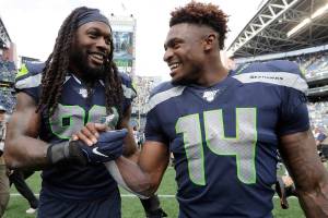Seattle Seahawks defensive end Jadeveon Clowney, left, talks with teammate D.K. Metcalf after they defeated the Cincinnati Bengals on Sunday in Seattle. (AP Photo/John Froschauer)
