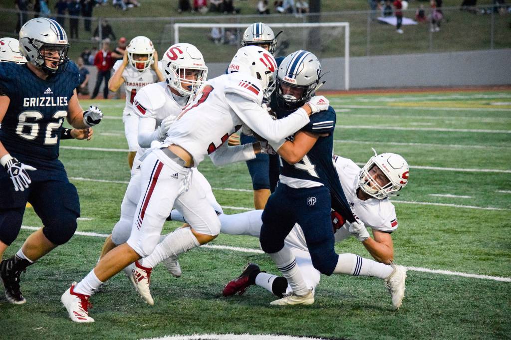 Senior wide receiver Jace Handshy chargers through the Snohomish defense on Friday, Sept. 13 at Veterans Memorial Stadium. (Katie Webber / The Herald)