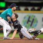 The White Soxs Adam Engel (right) collides with Mariners shortstop J.P. Crawford after getting tagged out while attempting to steal second base during the second inning of a game Sept. 13, 2019, in Seattle. (AP Photo/Stephen Brashear)