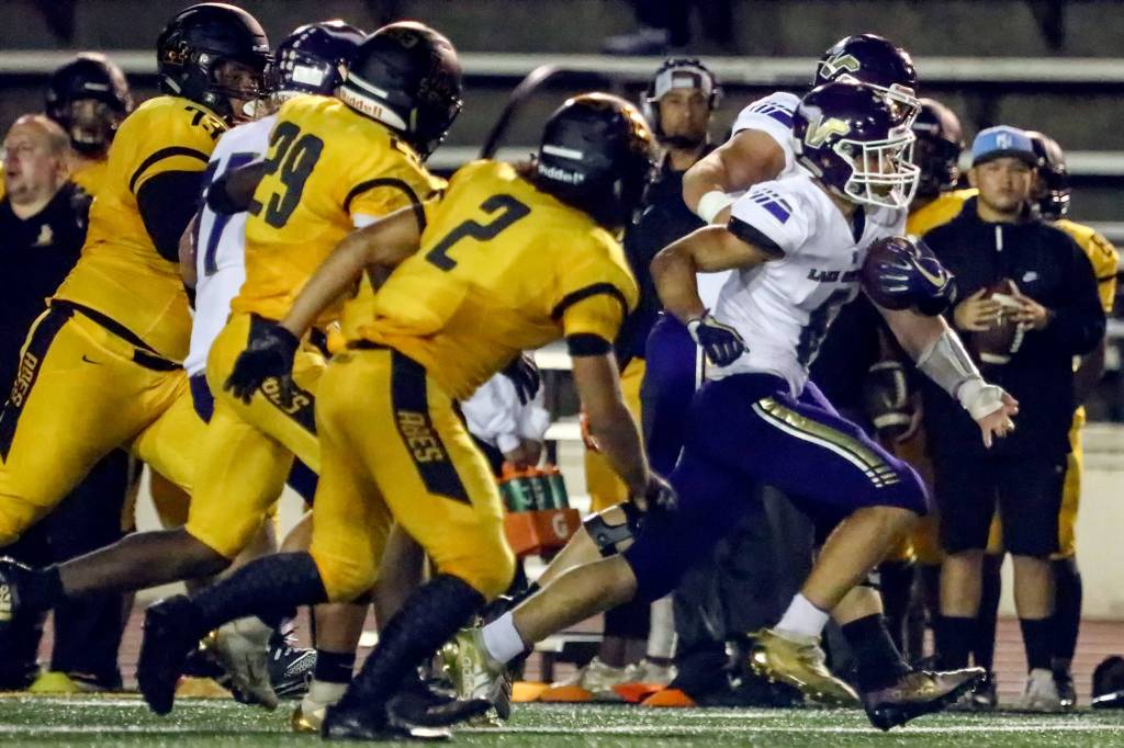 Lake Stevens Dallas Landeros leads the Lincoln defenders in a foot race Friday night at Lincoln Bowl in Tacoma on September 13, 2019. Lake Stevens won 35-26. (Kevin Clark / The Herald)