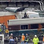 Train cars are jumbled together with vehicles below a railroad bridge at the scene of an Amtrak train crash onto I-5 on Dec. 19, 2017, in DuPont, Washington. (AP Photo/Elaine Thompson, file)