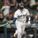 The Mariners Omar Narvaez tosses his bat after hitting a solo home run off White Sox relief pitcher Alex Colome during the 10th inning of a game Sept. 14, 2019, in Seattle. (AP Photo/Stephen Brashear)