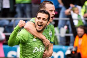 Seattle Sounders midfielder Victor Rodriguez (left) and defender Brad Smith celebrate after Smith scored a goal against the New York Red Bulls on Sunday at CenturyLink Field in Seattle. (Joshua Bessex/The News Tribune via AP)