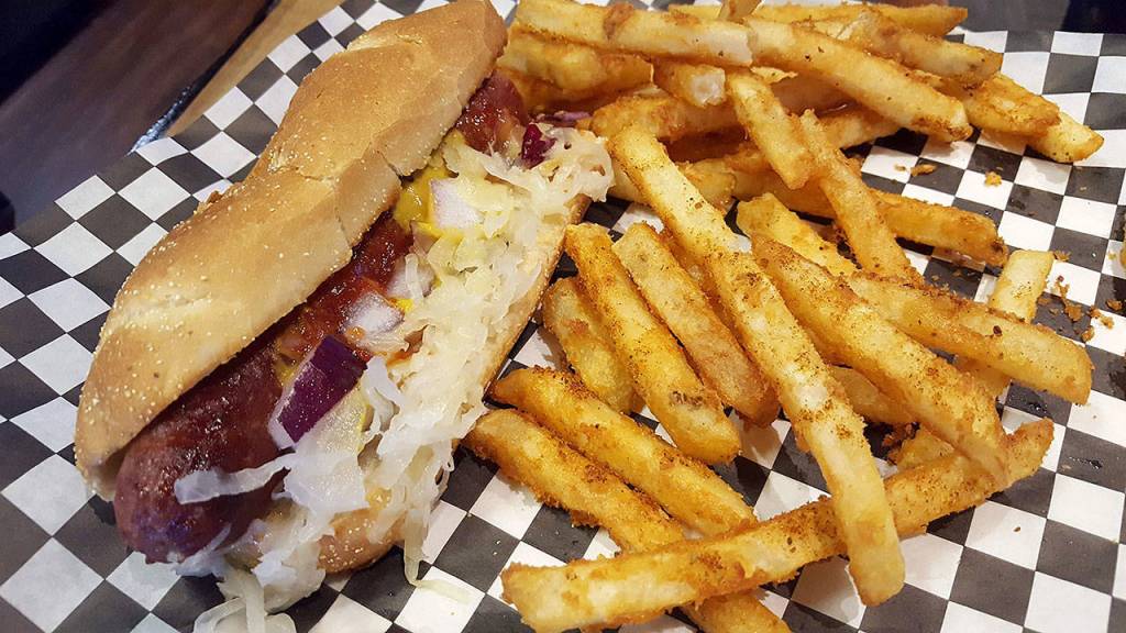 The Polish sausage is topped with ketchup, mustard, sauerkraut, onion and a choice of chili, nacho cheese or cheddar on a toasted bun. (Evan Thompson / The Herald)