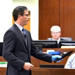 Snohomish County deputy prosecutor Robert Grant illustrates the distance Encarnacion Salas walked through an apartment with a knife, to kill Jesus Jesse Cardenas Lopez, during a rebuttal argument at Salas murder retrial on Sept. 16 in Everett. (Caleb Hutton / The Herald)