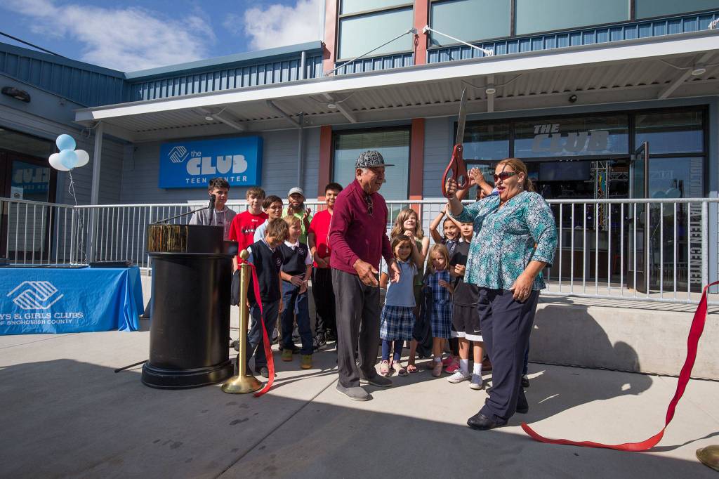 Tulalip Board of Directors Chairwoman Teri Gobin celebrates with kids and Herman Williams Sr. after cutting the ribbon on Wednesday for the new multimedia teen center at the Tulalip Boys & Girls Club. (Andy Bronson / The Herald)