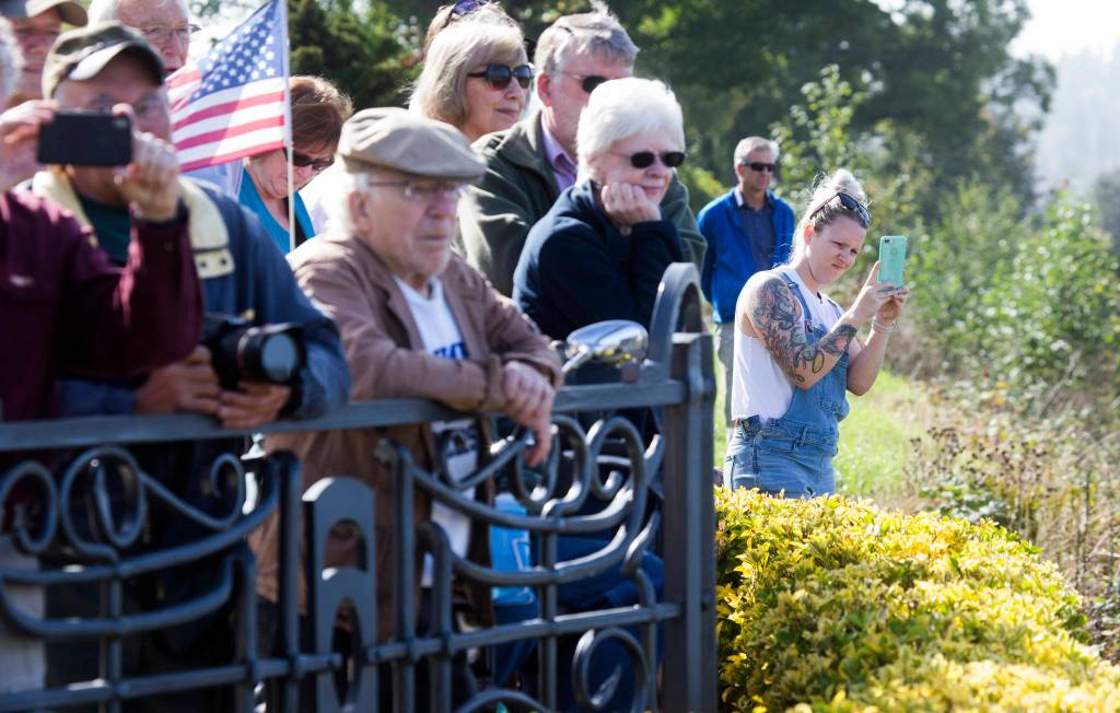 A crowd of people watch the Grand Avenue Park Bridge as it is slowly rotated into place along Marine View Drive on Wednesday in Everett. (Andy Bronson / The Herald)