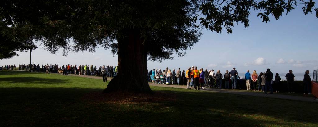 Grand Avenue Park is lined with bystanders as the $20 million Grand Avenue Park Bridge is slowly rotated into place along W Marine View Drive in Everett on Wednesday. (Andy Bronson / The Herald)