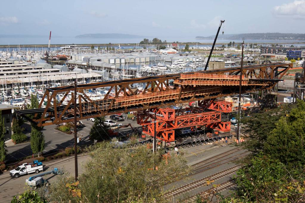 The Grand Avenue Park Bridge is slowly rotated between power poles Wednesday. (Andy Bronson / The Herald)