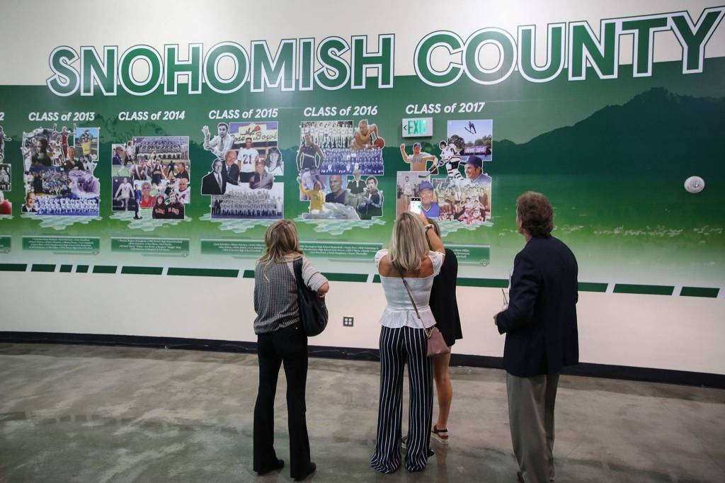 Attendees take in the Snohomish County Sports Hall of Fame during the 10th Annual Snohomish County Sports Hall of Fame Banquet Wednesday evening at Angel of the Winds Arena in Everett. (Kevin Clark / The Herald)