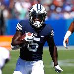 BYU running back TySon Williams (5) carries the ball as Southern Californias Olaijah Griffin (2) and Jay Tufele (78) pursue him during the Cougars win over the Trojans on Sept. 14 in Provo, Utah. (AP Photo/George Frey)