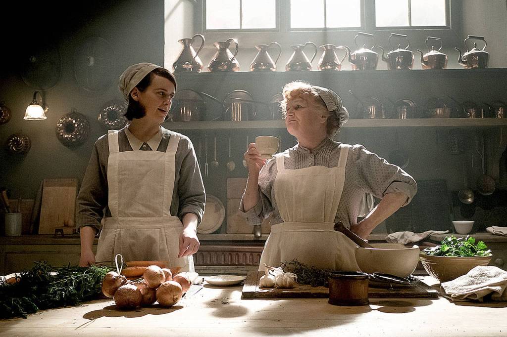 Daisy Mason (left, played by Sophie McShera) and Mrs. Patmore (Lesley Nicol) slave away in the kitchen in Downton Abbey.