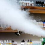 In this Sept. 3 photo, a salesman at a vape shop exhales while using an e-cigarette in Maine. (AP Photo/Robert F. Bukaty)