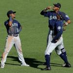 Mariners outfielders Shed Long (39), Keon Broxton (right rear) and Kyle Lewis celebrate after the final out of the 11th inning in a 6-5 win over the Pirates on Sept. 19, 2019, in Pittsburgh. (AP Photo/Gene J. Puskar)