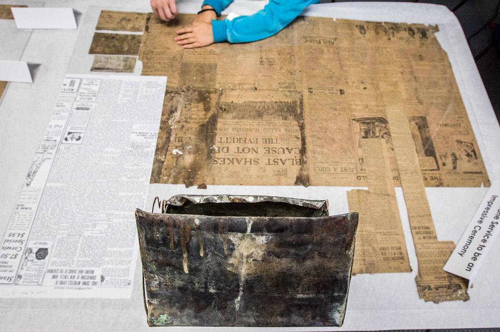 The old time capsule sits on display along with some of the contents found inside during the YMCAs time capsule ceremony on Saturday, Sept. 21, 2019 in Everett, Wash. (Olivia Vanni / The Herald)