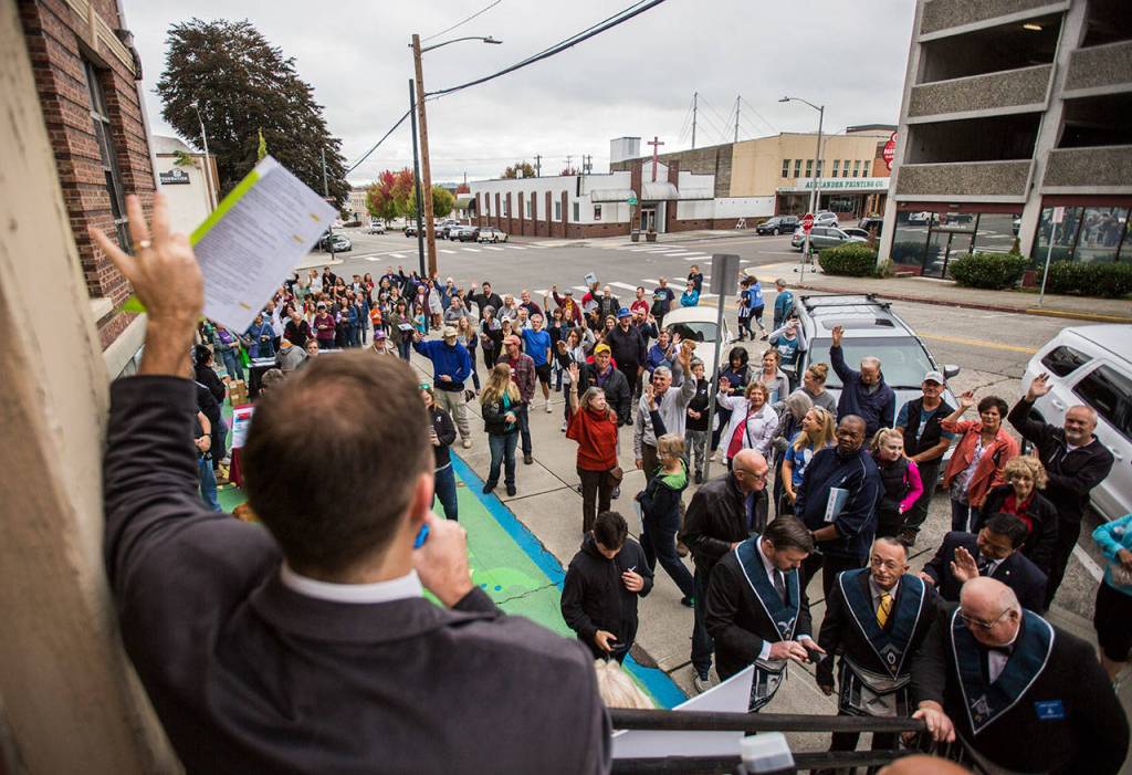 People raise their hands indicating how long they have been members of the YMCA during the YMCAs time capsule ceremony on Saturday, Sept. 21, 2019 in Everett, Wash. (Olivia Vanni / The Herald)