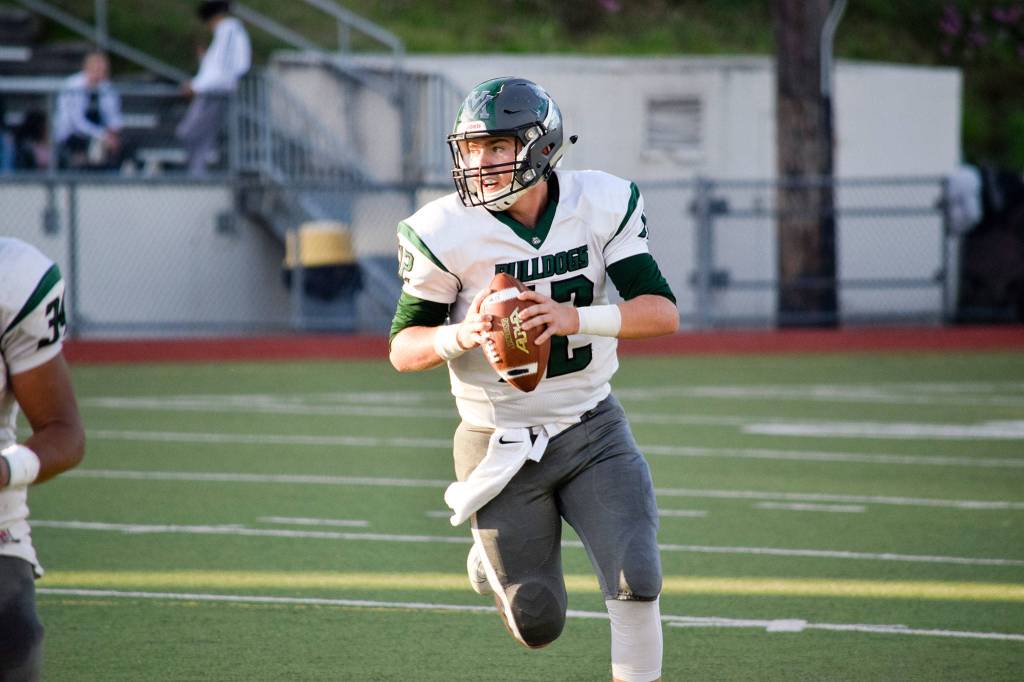 Senior quarterback Skyler Jensen looks for an open receiver against Cascade on Friday, Sept. 20 at Everett Memorial Stadium. (Katie Webber / The Herald)