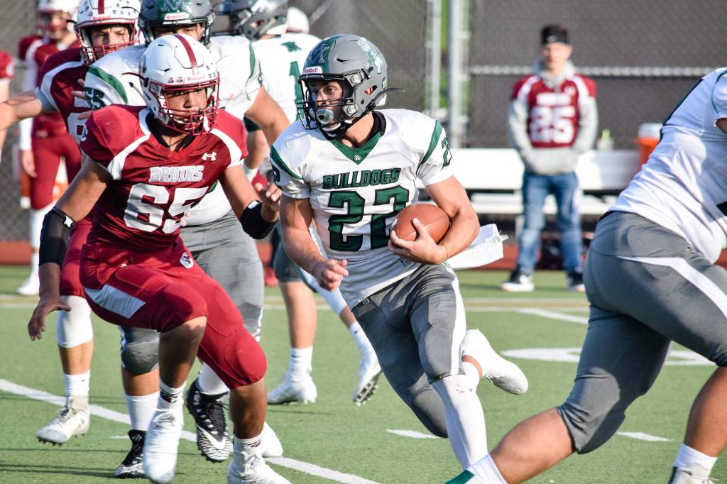 Senior running back Trevor Beaner runs through the Cascade defense on Friday, Sept. 20 at Everett Memorial Stadium. (Katie Webber / The Herald)