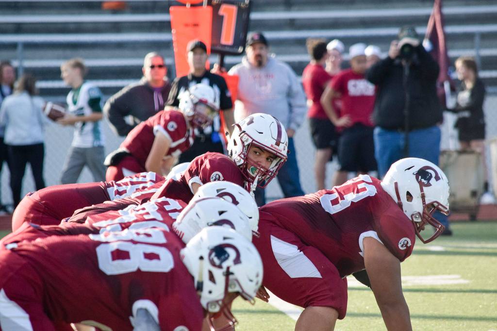 Junior quarterback Francisco Beltran looks to his right before starting a play against Mount Vernon on Friday, Sept. 20 at Everett Memorial Stadium. (Katie Webber / The Herald)