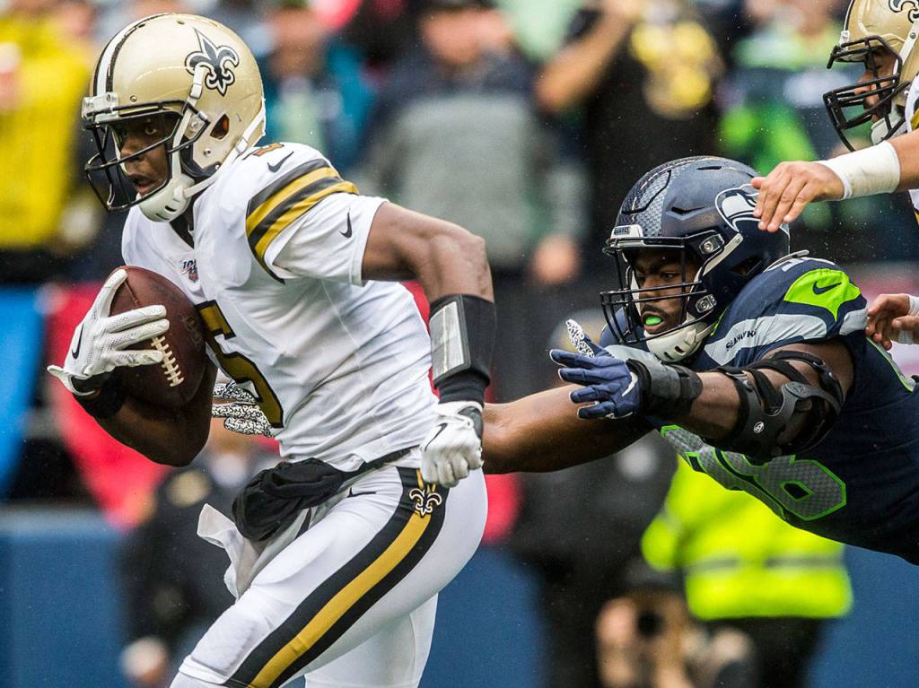 Seattles Rasheem Green dives for New Orleans Teddy Bridgewater on Sunday during the game against the New Orleans Saints at CenturyLink Field in Seattle. (Olivia Vanni / The Herald)
