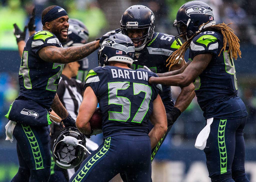Seahawks celebrate with Seattles Cody Barton after he recovers a fumble Sunday during the game against the New Orleans Saints at CenturyLink Field in Seattle. (Olivia Vanni / The Herald)