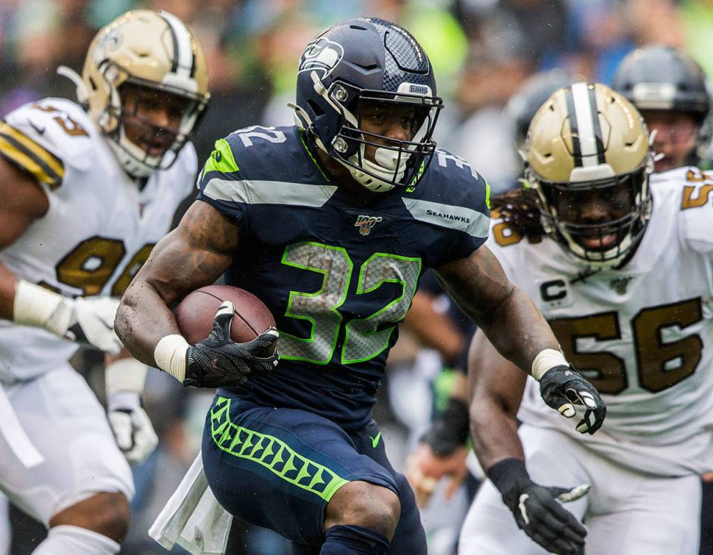 Seattles Chris Carson runs the ball Sunday during the game against the New Orleans Saints at CenturyLink Field in Seattle. (Olivia Vanni / The Herald)
