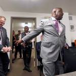 Former state Sen. Jesse Wineberry (right) playfully points out Tim Eyman behind him before a news conference on initiative I-1000, on Oct. 11, 2018, in Seattle. (AP Photo/Elaine Thompson, file)