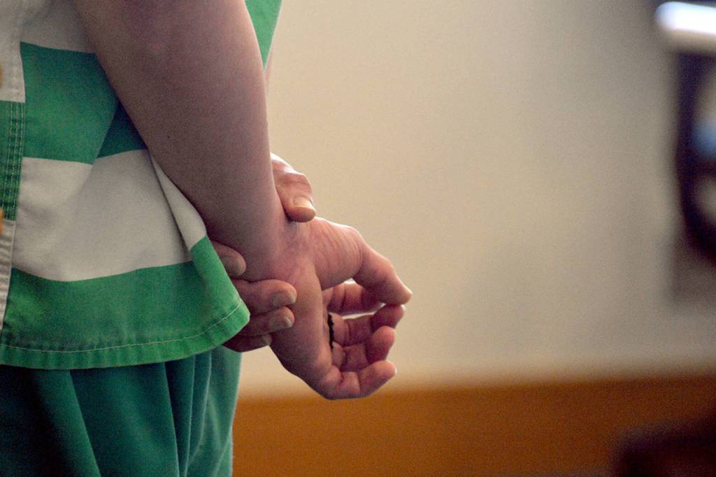 Encarnacion Salas holds his hands behind his back Wednesday, as a judge sentences him to 20 years in prison for second-degree murder. (Caleb Hutton / The Herald)