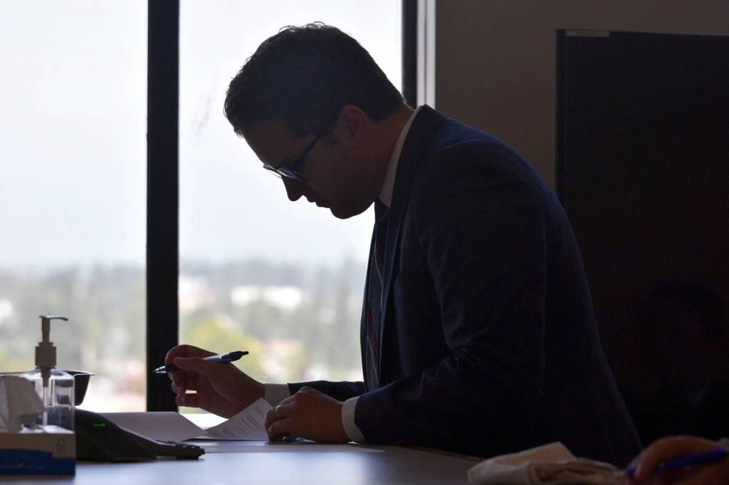 Deputy prosecutor Tyler Scott reviews sentencing paperwork Wednesday in the murder case of Encarnacion Salas. (Caleb Hutton / The Herald)
