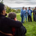 Ann Fields, right, Pam Fields, and LaTonage Kelly speak to a group of family, friends and officials involved in Ezekiel Kellys murder case at a bench dedication at the Rosehill Community Center on Saturday in Mukilteo. (Olivia Vanni / The Herald)