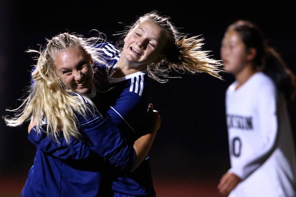Glacier Peaks Annika Lambott and Chloe Seelhoff celebrate Lambotts goal in the second half Tuesday night at Glacier Peak High School in Snohomish on September 24, 2019. Glacier Peak won 5-1. (Kevin Clark / The Herald)