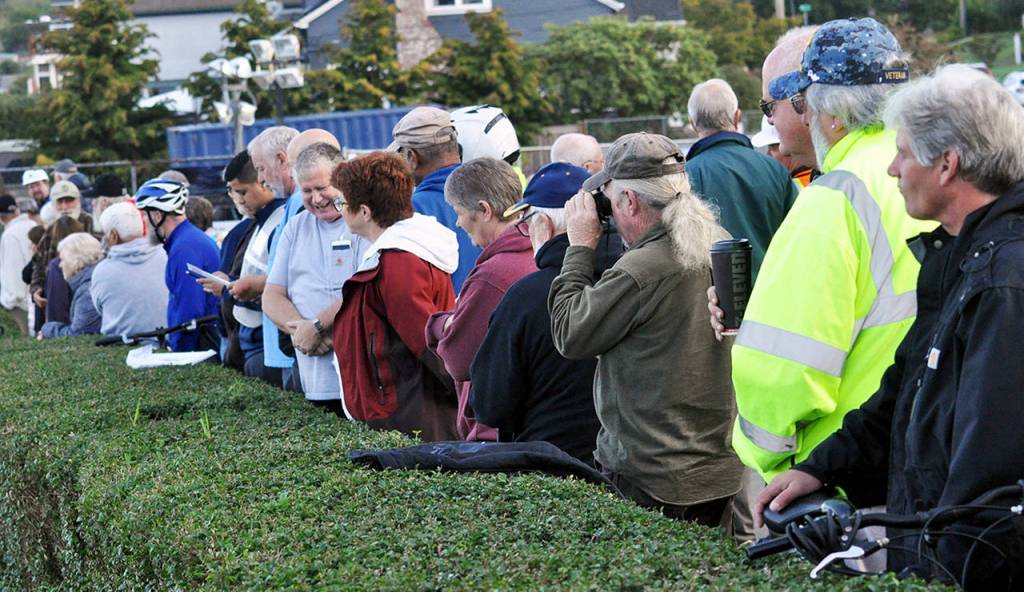 Lots of folks came out to watch the Grand Ave. Bridge on Wednesday morning. (Sue Misao / The Herald)