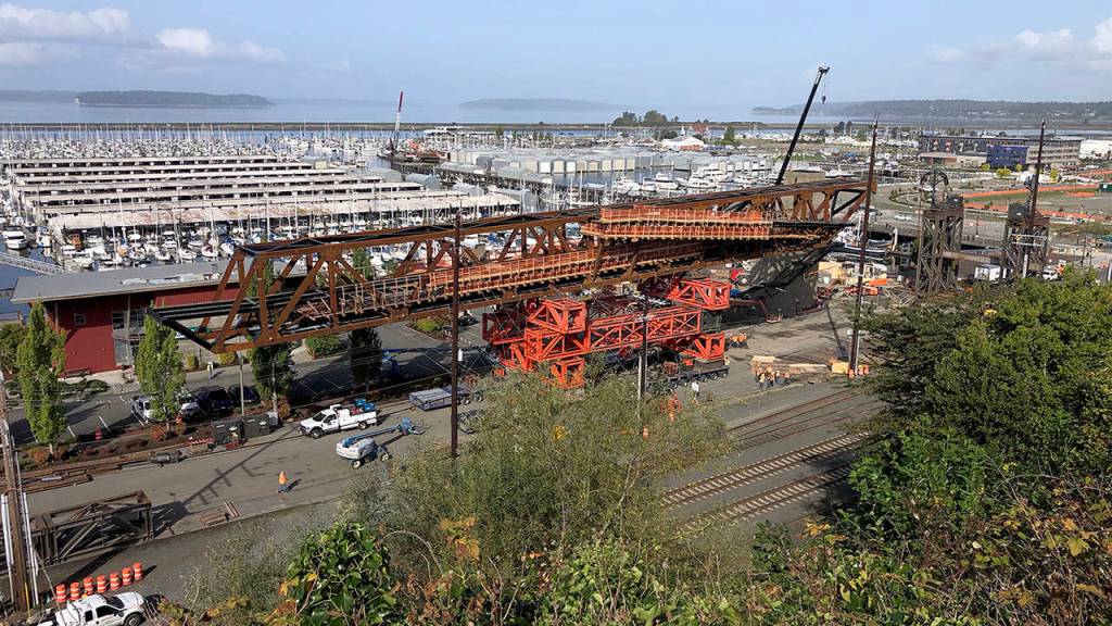 Crews (lower right) reinforce the road. (Andy Bronson / The Herald)